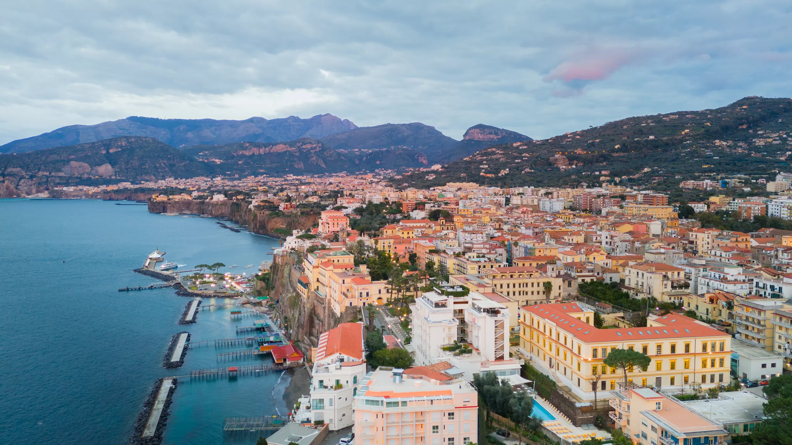 A cliffside coastal town and harbor from the air